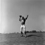 Photograph: [Football player #15, George Woodrow, set to throw a football]
