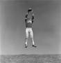 Photograph: [Football player #36, John Edwards, mid air arms stretched above his …