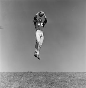 Primary view of object titled '[Football player #36, John Edwards, catching a ball mid air]'.