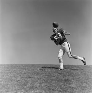 Primary view of object titled '[Football player #83, Barry Moore, catching a pass]'.