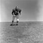 Photograph: [Football player #74, Gary Yancy, jogging and looking off camera]