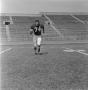 Photograph: [Football player number 74 running through a football field]
