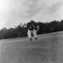 Photograph: [Football player running on the field, 65]