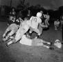 Photograph: [Football players tackling each other]