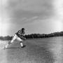 Photograph: [Football player #44, Fred Woods, running with a ball to initiate a d…