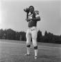 Photograph: [Football player George Woodrow posing in a passing position]