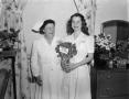 Photograph: [Two nurses with flowers]