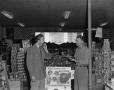 Photograph: [Frank Mills and another man at a grocery store]