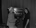 Photograph: [Two women stand with television camera]