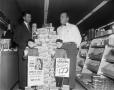 Photograph: [Two men with a Philip Morris display]
