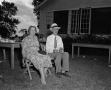 Photograph: [Man and woman sitting outdoors]