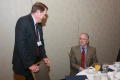 Photograph: [Greg Shrader talking with other guest at TDNA conference]