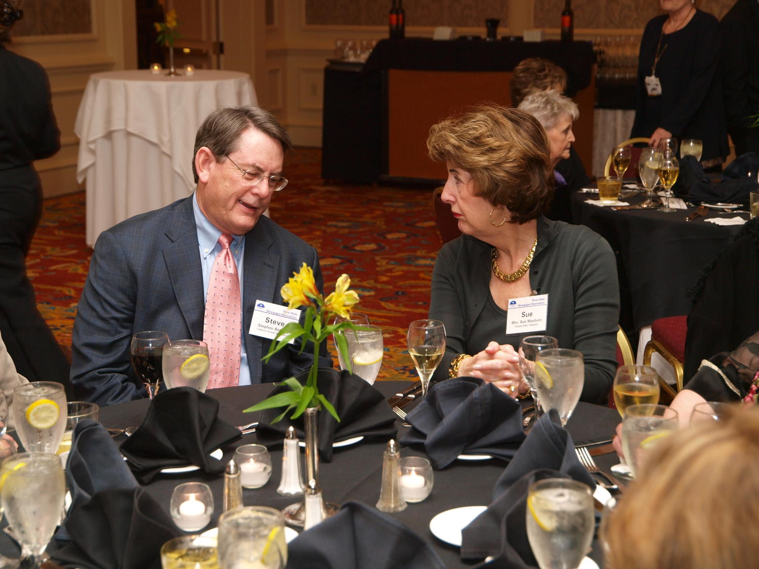 [Sue Mayborn attending TDNA dinner], Photograph of Sue Mayborn (right) sitting at a dinner table and chatting with a man identified as Stephen "Steve" Bea--, they are dressed in their finest attire, in attendance at the 2008 Texas Daily Newspaper Association annual conference awards dinner, held at The Westin Riverwalk Hotel in San Antonio, Texas., 