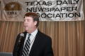 Photograph: [Unidentified man speaking into mic at TDNA conference]