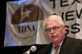 Primary view of [Charles Moser speaking into microphone during TDNA conference]