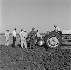 Primary view of object titled '[Men standing around a Ford tractor]'.