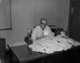 Photograph: [Man at desk with letters]