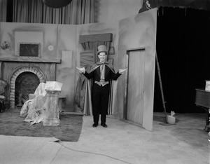 Primary view of object titled '[Man on set dressed in top hat and cape]'.