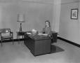 Photograph: [Woman sitting at a desk]