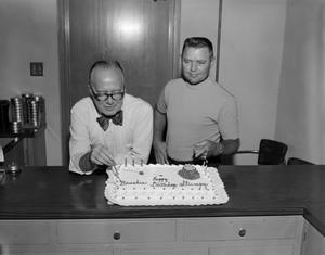 Primary view of object titled '[Two men and a birthday cake]'.