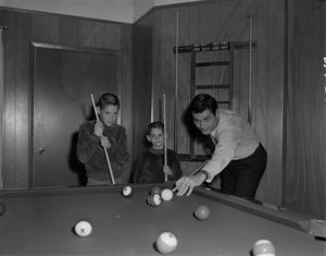 Primary view of object titled '[Bill Enis playing pool with his sons]'.