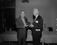 Photograph: [Roy Bacus handing out award to a man]