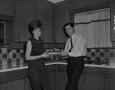 Photograph: [Bill Enis and his wife in the kitchen]