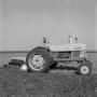Photograph: [Man on a tractor]