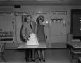 Photograph: [Roy Bacus and a woman around a cake]