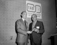Photograph: [Roy Bacus handing award to unknown man]