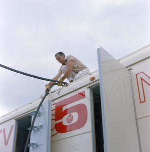 Primary view of object titled '[Man on top of WBAP truck]'.