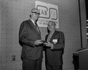 Primary view of object titled '[Mr. Bacus handing award at TAB meeting]'.