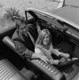 Photograph: [Mike Hoey in an automobile with a woman]