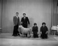 Photograph: [Four people with four poodles]