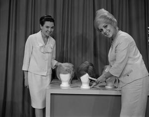 Primary view of object titled '[Bobbie and guest with wigs on Dateline]'.