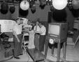 Photograph: [Thaine Engle and others examining equipment 1]