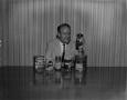 Photograph: [Man with variety of coffee products]