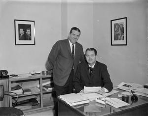 Primary view of object titled '[Two WBAP employees posing in the office]'.