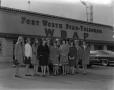 Photograph: [Models in front of WBAP building]