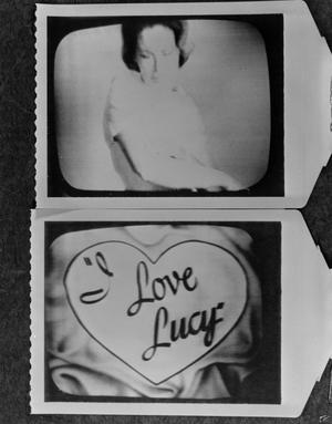 Primary view of object titled '[2 still images from "I Love Lucy" playing on a television set]'.
