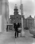 Photograph: [Reporter in front of the Tarrant County Courthouse]
