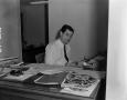 Photograph: [Bill Enis at his desk]