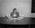Photograph: [Man with Morton products on desk]