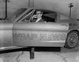 Photograph: [Reporter in a WBAP mustang]