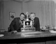 Photograph: [Bob Gould and Roy Bacus with a trophy]