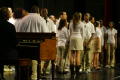 Thumbnail image of item number 1 in: '[Choir members gather around mics on stage]'.