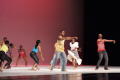 Primary view of [Photograph of nine individuals performing a dance on stage]