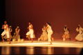 Photograph: [Photograph of nine dancers performing on a stage]