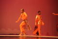 Thumbnail image of item number 1 in: '[Photograph of two men standing on stage in orange clothing]'.