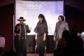 Photograph: [Pam Grier and Curtis King stand on stage with woman]